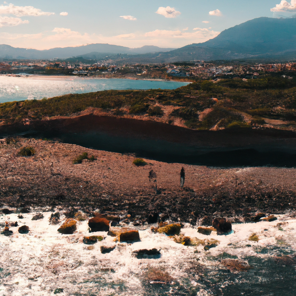 Aerial coast with small group walking a cliffside path at golden hour